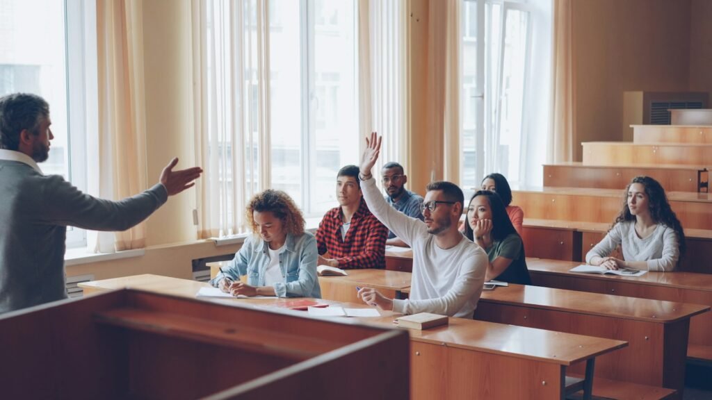 Students raising their hands to take part in a class