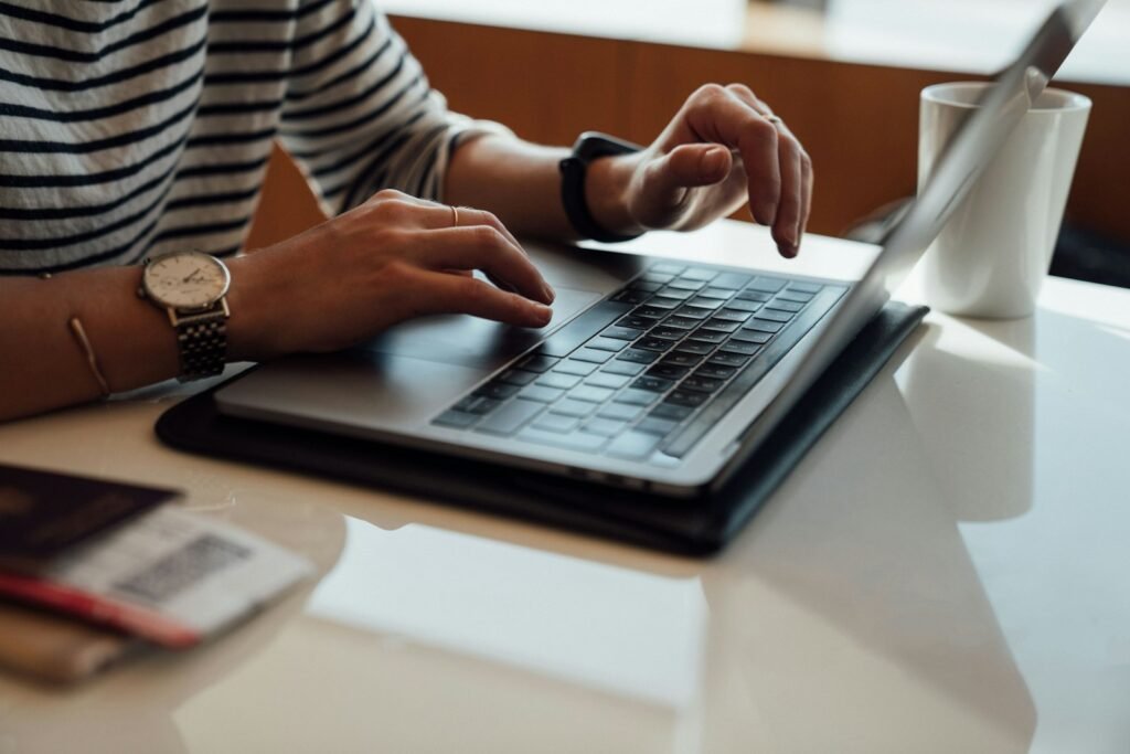 A learner working at a table on a laptop